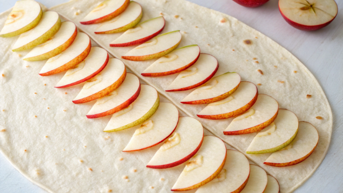 Adding apple slices to tortilla